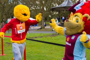 High-five Honey monster to Aston Villa Mascot
